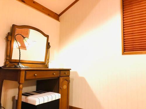 a dressing table with a mirror on top of it at 森の香 in Matsue
