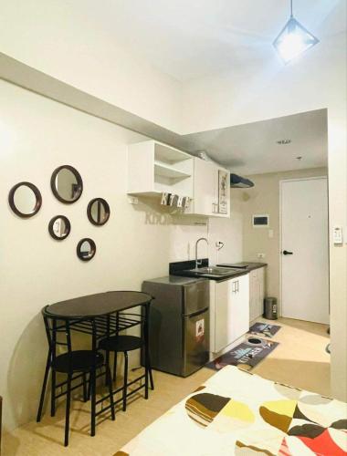 a kitchen with a table and chairs in a room at 2313 Sun Vida Tower in Cebu City