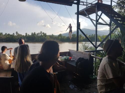 a group of people on a boat on a river at The Hideaway in Kampot