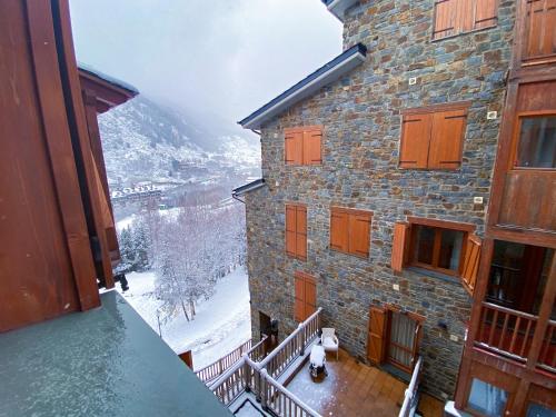 a view from a balcony of a building in the snow at Naturaleza En Soldeu - Disfruta En Familia - Parking Gratis l by BonesVacances in Soldeu