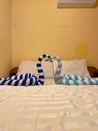 a bed with blue and white blankets on it at Sweet View Guesthouse in Koh Rong