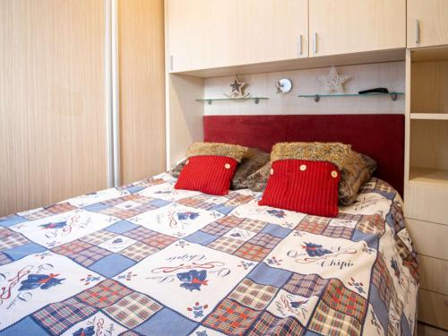 a bedroom with a bed with a quilt on it at Moderne appartement 4 pers à Val Thorens avec WiFi et balcon - FR-1-637-37 in Val Thorens