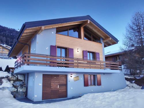 a house with a garage in the snow at Chalet Etoile Polaire in Nendaz