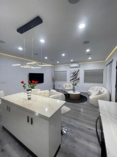 a living room with white furniture and a tv at Luxury 2 bedroom villa in Huntington Beach