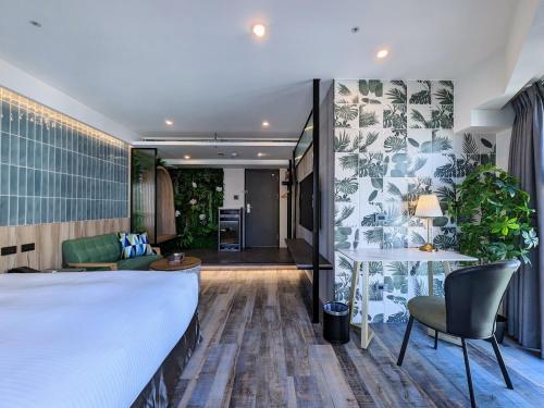 a hotel room with a bed and a living room at K Hotel - Yizhong in Taichung