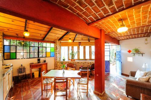 a living room with a table and a couch at Casa Aurora in Ajijic