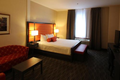 a hotel room with a bed and a couch at Hotel Chrome Montreal Centre-Ville in Montréal
