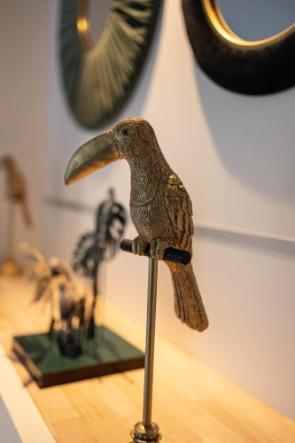 a figurine of a bird sitting on a pole at Les Granges de Jules in Lafitte-Vigordanne
