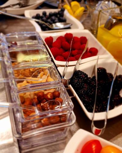 a table topped with trays of different types of food at Casalgrande Hotel in Salvaterra