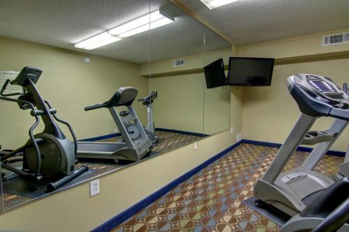 a gym with two tread machines and a flat screen tv at InTown Suites Extended Stay Marietta GA - Roswell Rd in Marietta