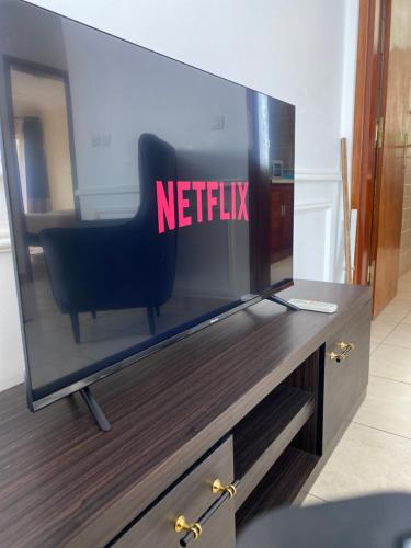 a television with the netflix sign on it at Armelle Sweet Home in Douala