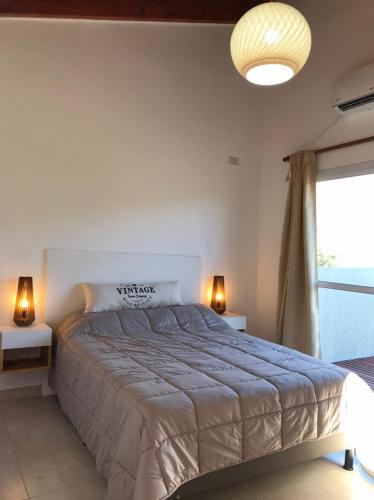 a bedroom with a large bed and a window at Mirador Merlo in Merlo