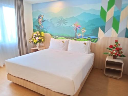 查亞普拉的住宿－MaxOneHotels at Jayapura，卧室配有一张白色大床和壁画