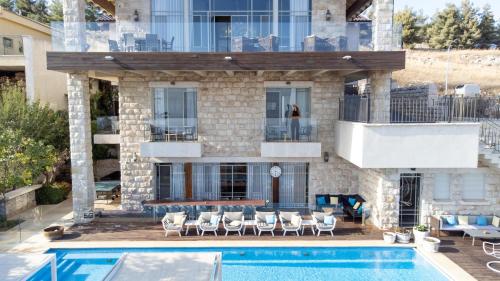 a house with a swimming pool in front of a building at Chateau Glili in Safed