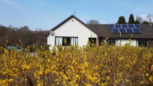 a house with solar panels on the roof at Beech House in Fort William