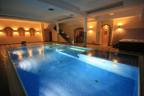 a large swimming pool in the middle of a room at Dwór Ostoia in Rymanów