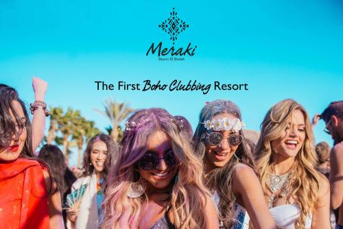 a group of people posing for a picture at a music festival at Meraki Resort Sharm El Sheikh Adults only in Sharm El Sheikh