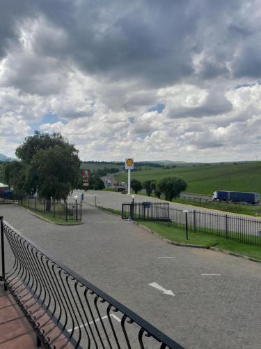 a road with a fence on the side of it at Protea Hotel by Marriott Harrismith Montrose in Harrismith