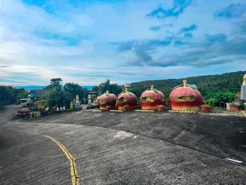 four large pumpkins sitting in the middle of a road at La Virginia Leisure Park and Amusement in Mataasnakahoy