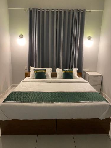 a bedroom with a large bed in front of a window at HOLLYWOOD Rooms in Sultan Bathery