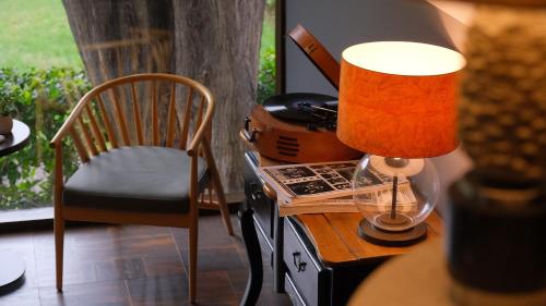 a lamp sitting on a table next to a chair at Marin Otel & Restaurant in Samsun