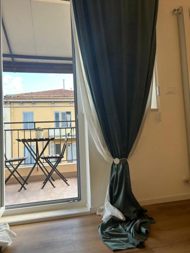 a room with a window with a table and a balcony at Civico 28 in Pescara