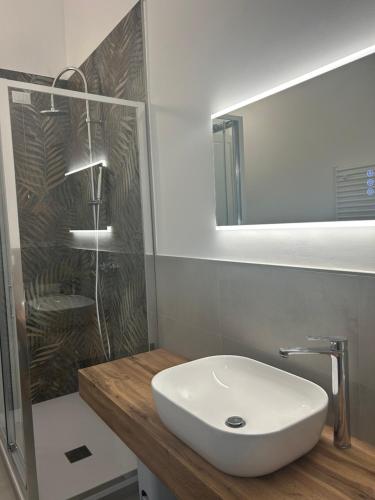a bathroom with a white sink and a mirror at Civico 28 in Pescara