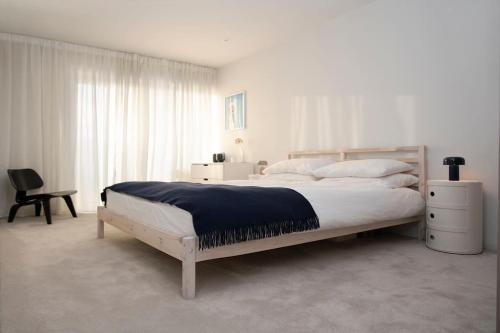 a white bedroom with a large bed and a window at THE VIEW by condokeeper in London