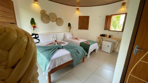 a bedroom with two beds in a room at Oka Pousada Atins in Atins