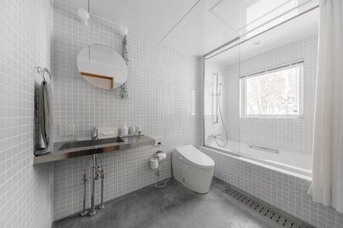a bathroom with a toilet and a sink and a mirror at 6ty6 - Vacation STAY 18030v in Niseko