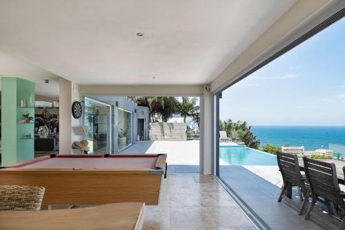 a pool table in a house with a view of the ocean at Madeleine Drive in Ballito