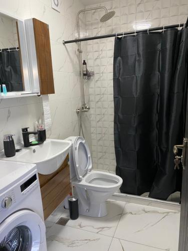 a bathroom with a toilet and a sink and a shower at White House near Borjomi Sadgeri in Borjomi