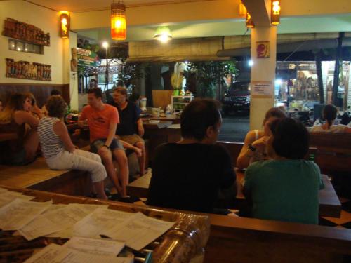 a group of people sitting in a bar at Gusti Home Stay Ubud in Ubud