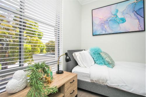 a living room with a couch and a window at CHILLAX HOUSE - Luxury, Canals, Jetty, Family Friendly - Sleeps 14 in Style! in Mandurah