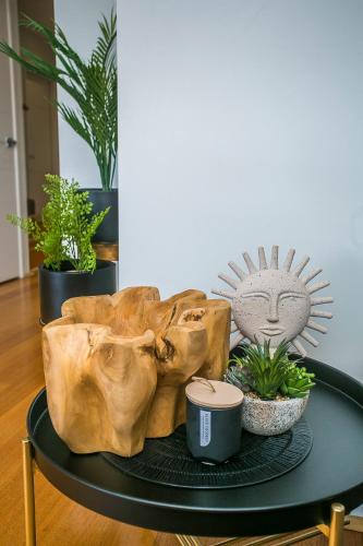 a table with some plants on top of it at CHILLAX HOUSE - Luxury, Canals, Jetty, Family Friendly - Sleeps 14 in Style! in Mandurah