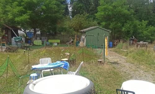 a backyard with a table and chairs and a shed at Casaroja in Wittenheim