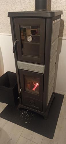 a wood stove with a fire in it at Casaroja in Wittenheim