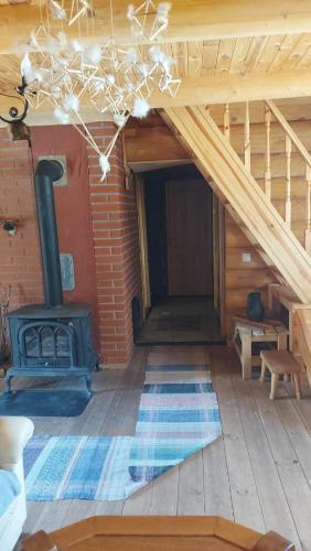 a room with a woodburning stove in a log cabin at Pirts māja Ramatas in Skulte