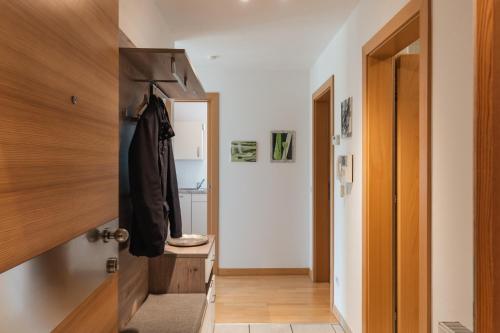 a hallway with a door leading to a bathroom at FaWa Apartments "Villa Mai" in Brunico