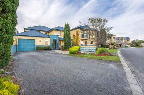 a house with a driveway in front of it at The Beach House At Bayside in Albany