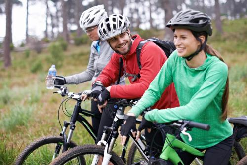 a group of three people riding bikes in a field at Hotel Bergland in Sillian