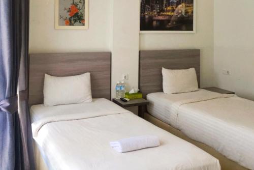 Postel nebo postele na pokoji v ubytování Twospaces Living at Maximus inn