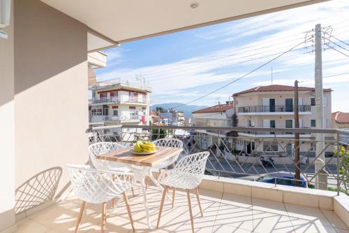 a balcony with a table and chairs and a view at Neos Marmaras Family Suite in Neos Marmaras