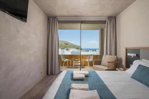 Un ou plusieurs lits dans un hébergement de l'établissement Corissia Beach hotel