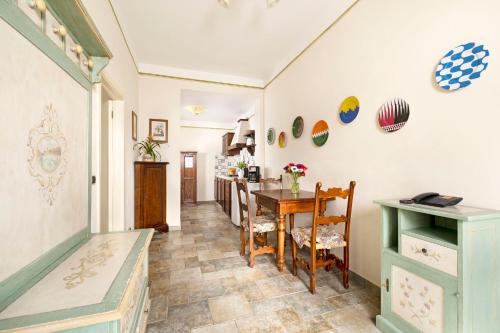 a kitchen with a table and a dining room at Borgo Grondaie in Siena