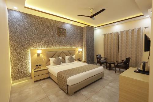 a hotel room with a bed and a table at THE BODHI PALACE RESORT in Bodh Gaya
