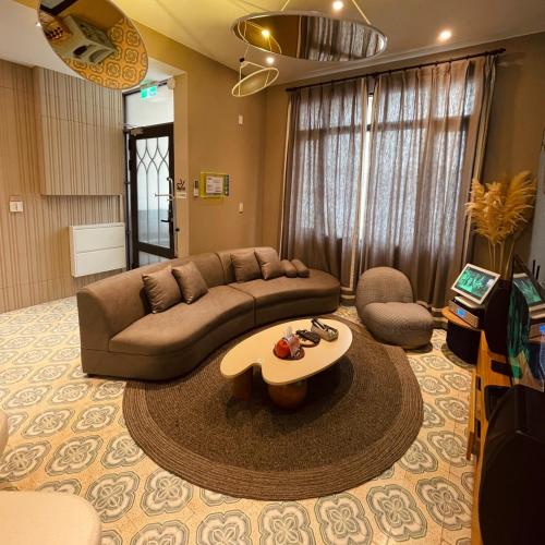 a living room with a couch and a table at Akasaka Family Villa in Anping