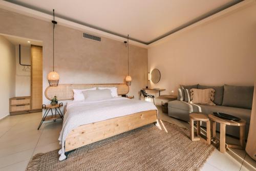 a bedroom with a bed and a couch at Villa Di Mare Seaside Suites in Ixia