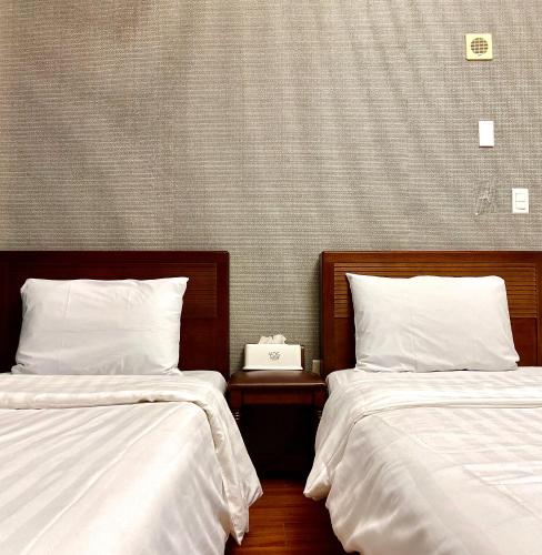 Ένα ή περισσότερα κρεβάτια σε δωμάτιο στο Myeongdong Merlin Hotel
