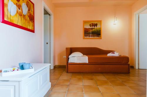 a living room with a couch and a tile floor at Calliope's Apartments - Stella del Mare in Siracusa